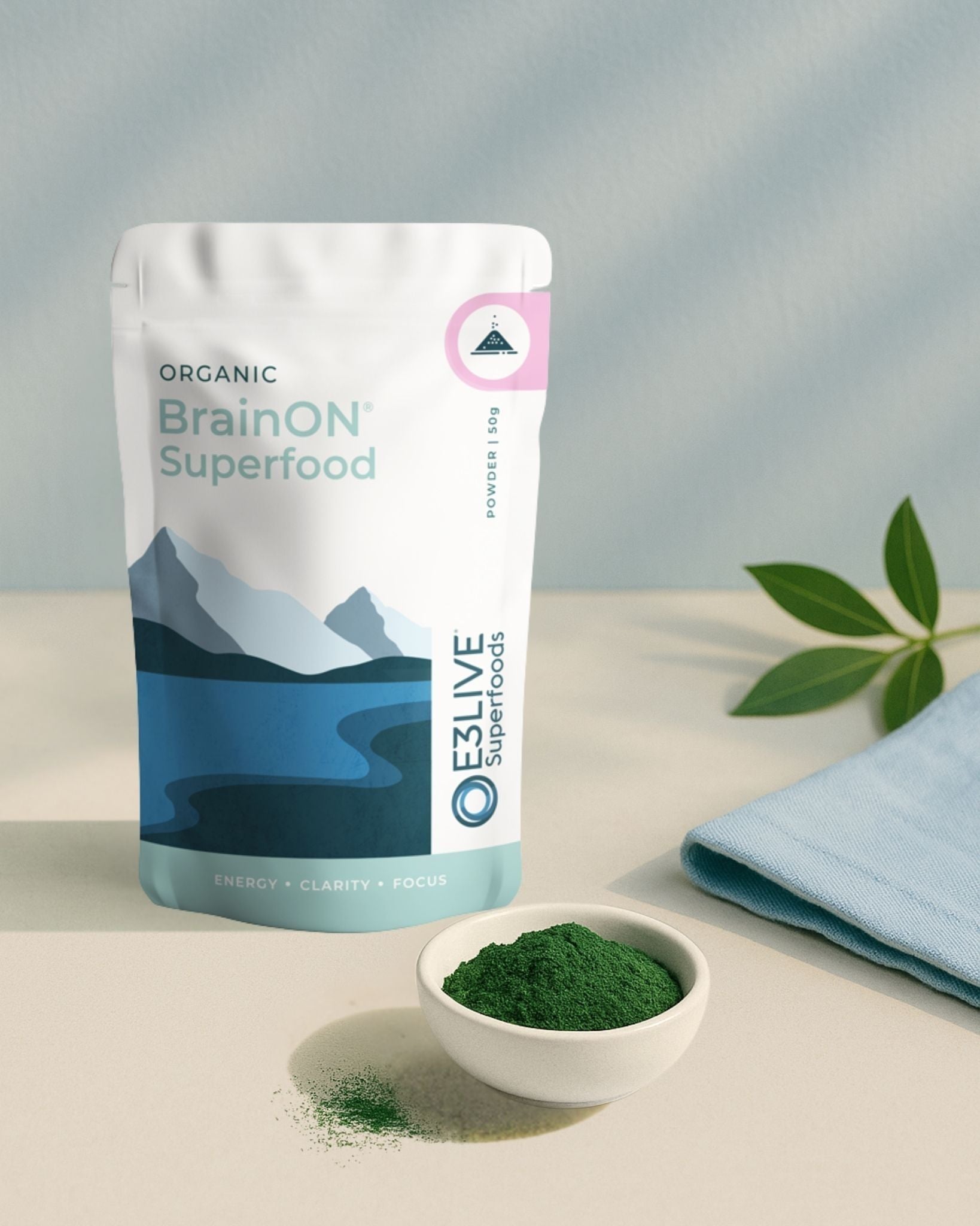 BrainON Superfood package with a bowl of green powder on a light surface
