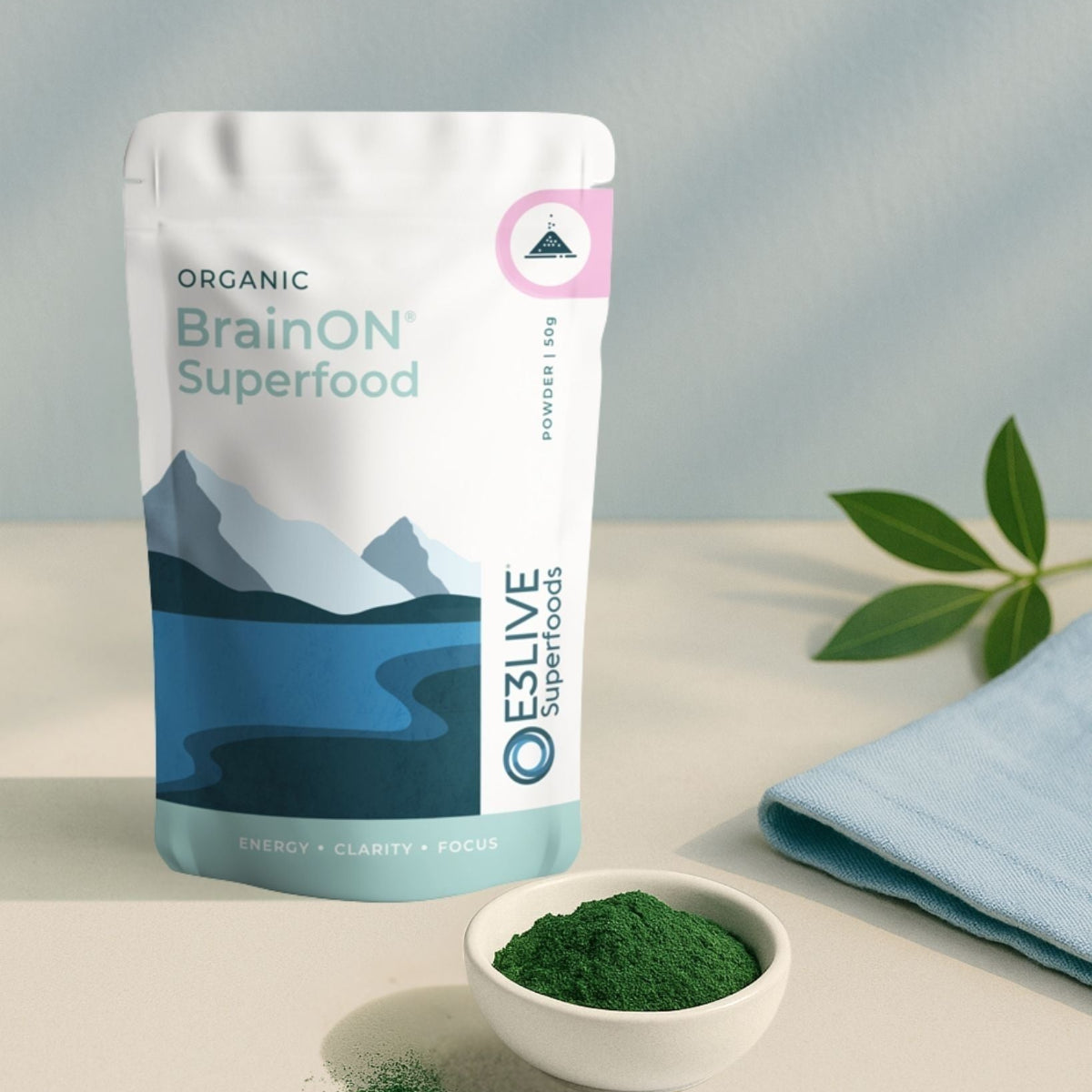 BrainON Superfood package with a bowl of green powder on a light surface