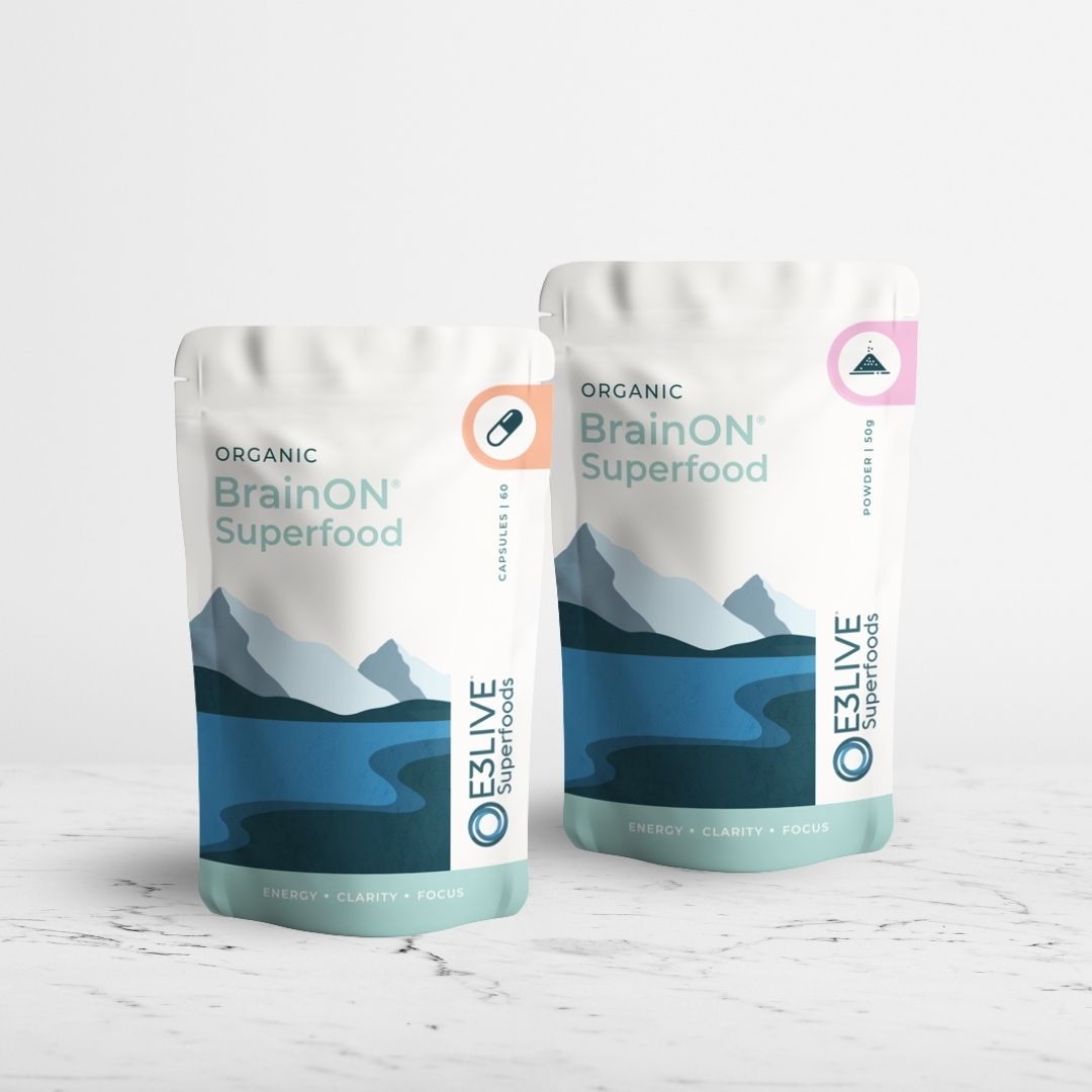 Two packs of Organic Brainon Superfood - one of capsules and one pack of powder - on a light grey background.