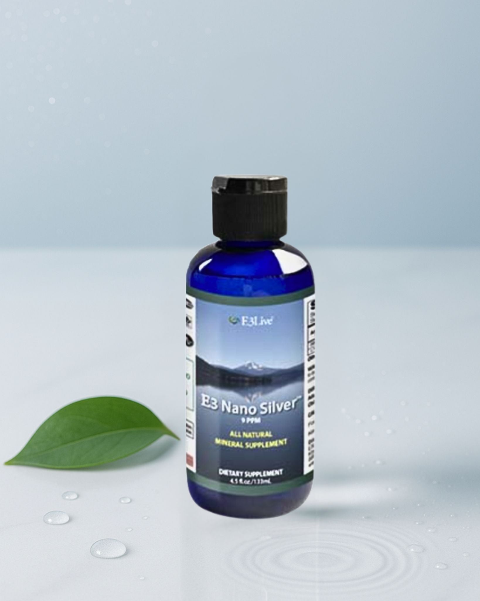 Bottle of E3 Nano Silver supplement with a green leaf on a light gray background