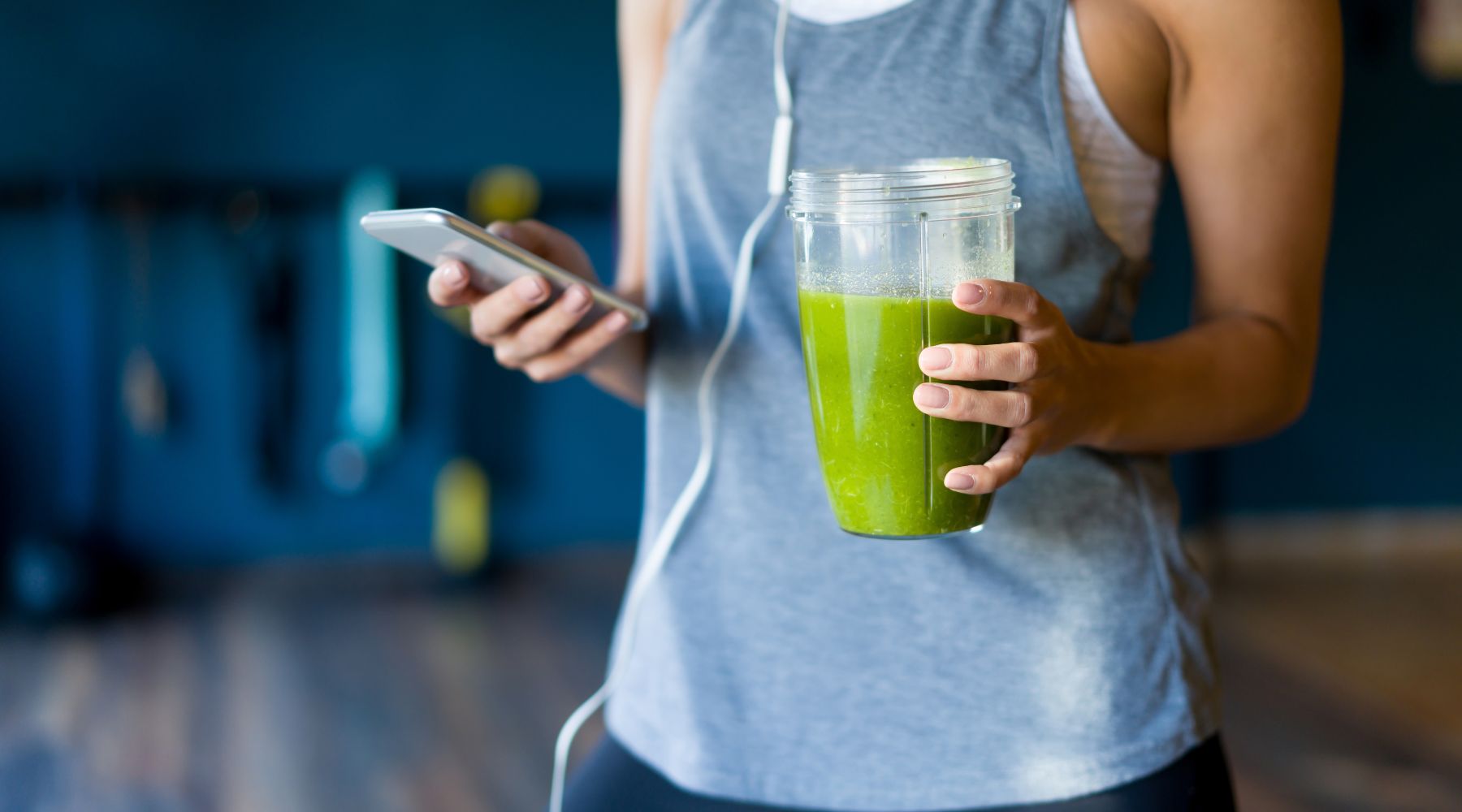Person holding a green superfood drink, representing BrainON products for enhanced focus, mental clarity, and sustained energy.