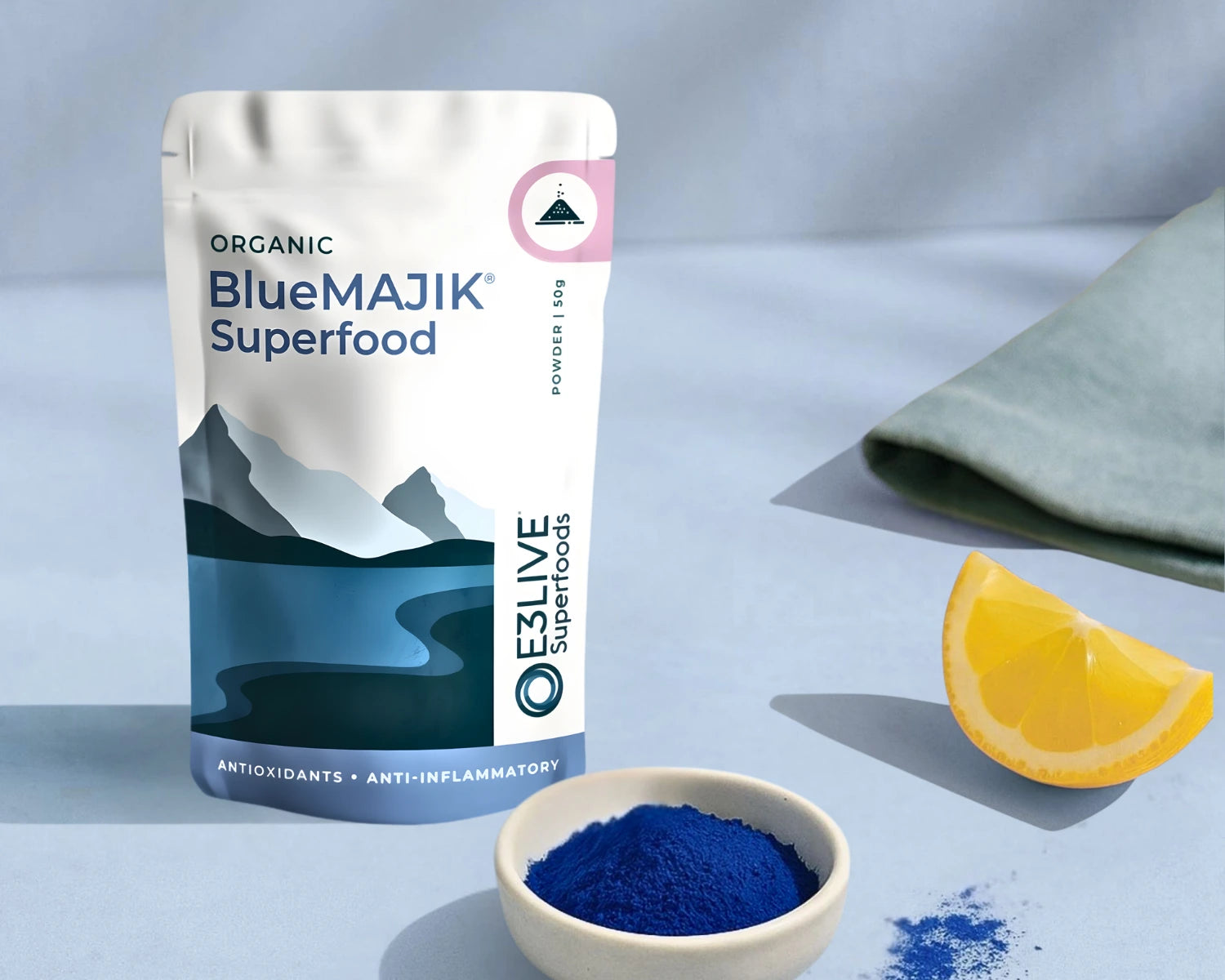 BlueMAJIK Superfood package with a bowl of powder and lemon wedge on a light blue background