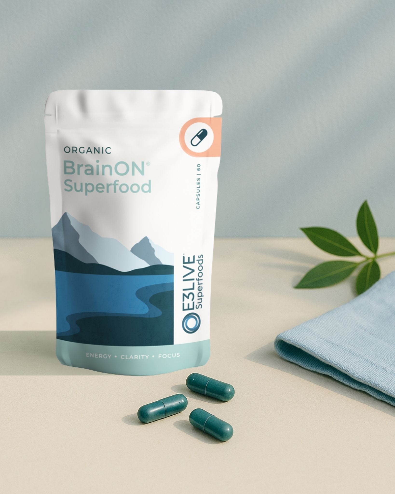 Packaging of Organic BrainON Superfood with capsules on a neutral background