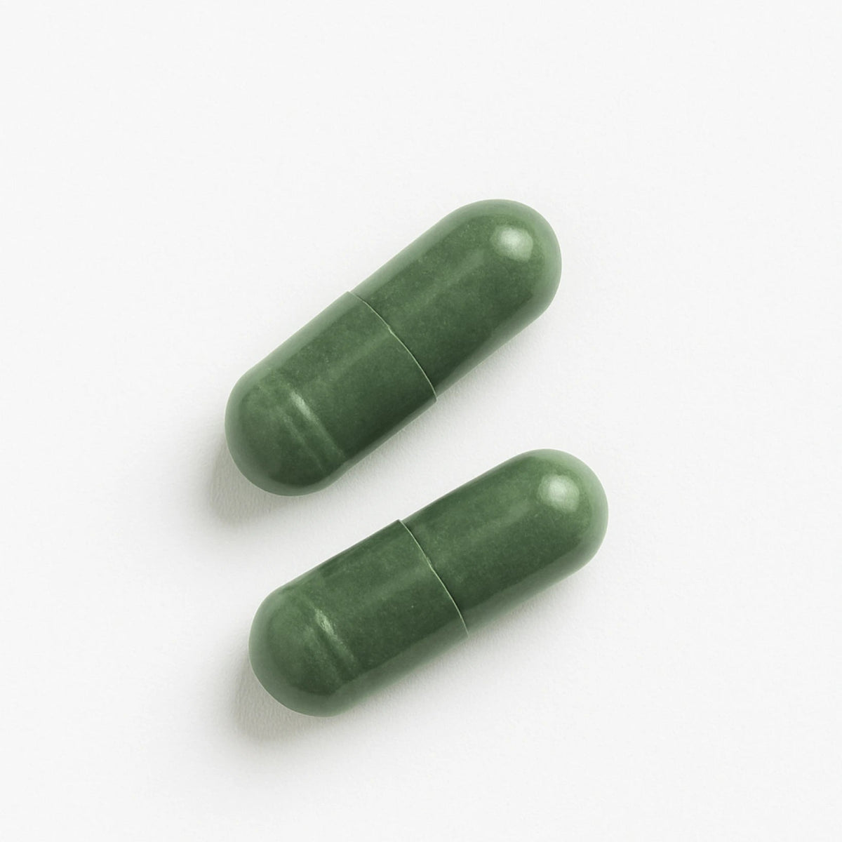 Two green BrainON capsules on a white background
