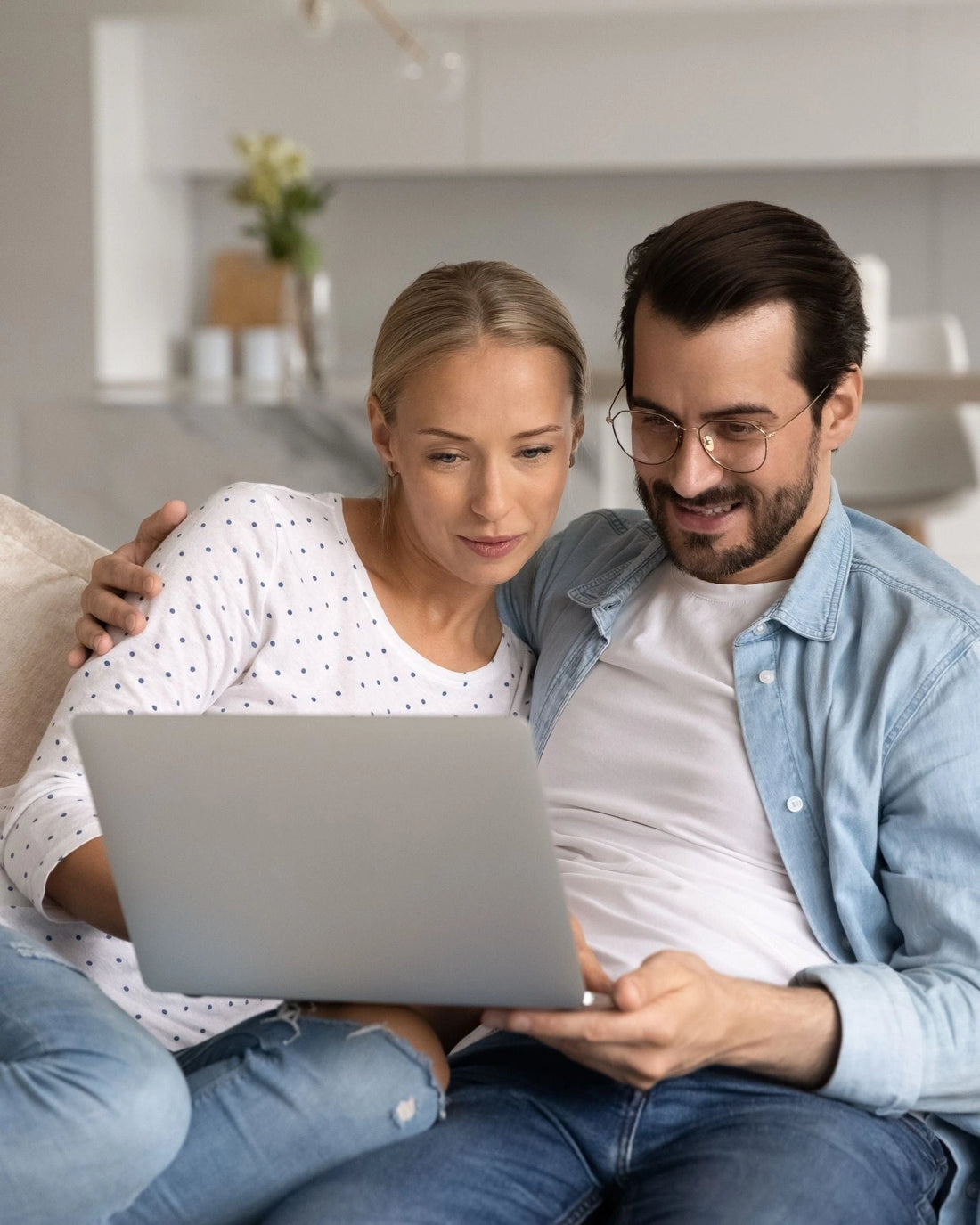 Couple focused on laptop