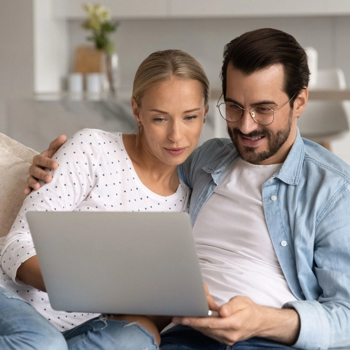 Couple focused on laptop