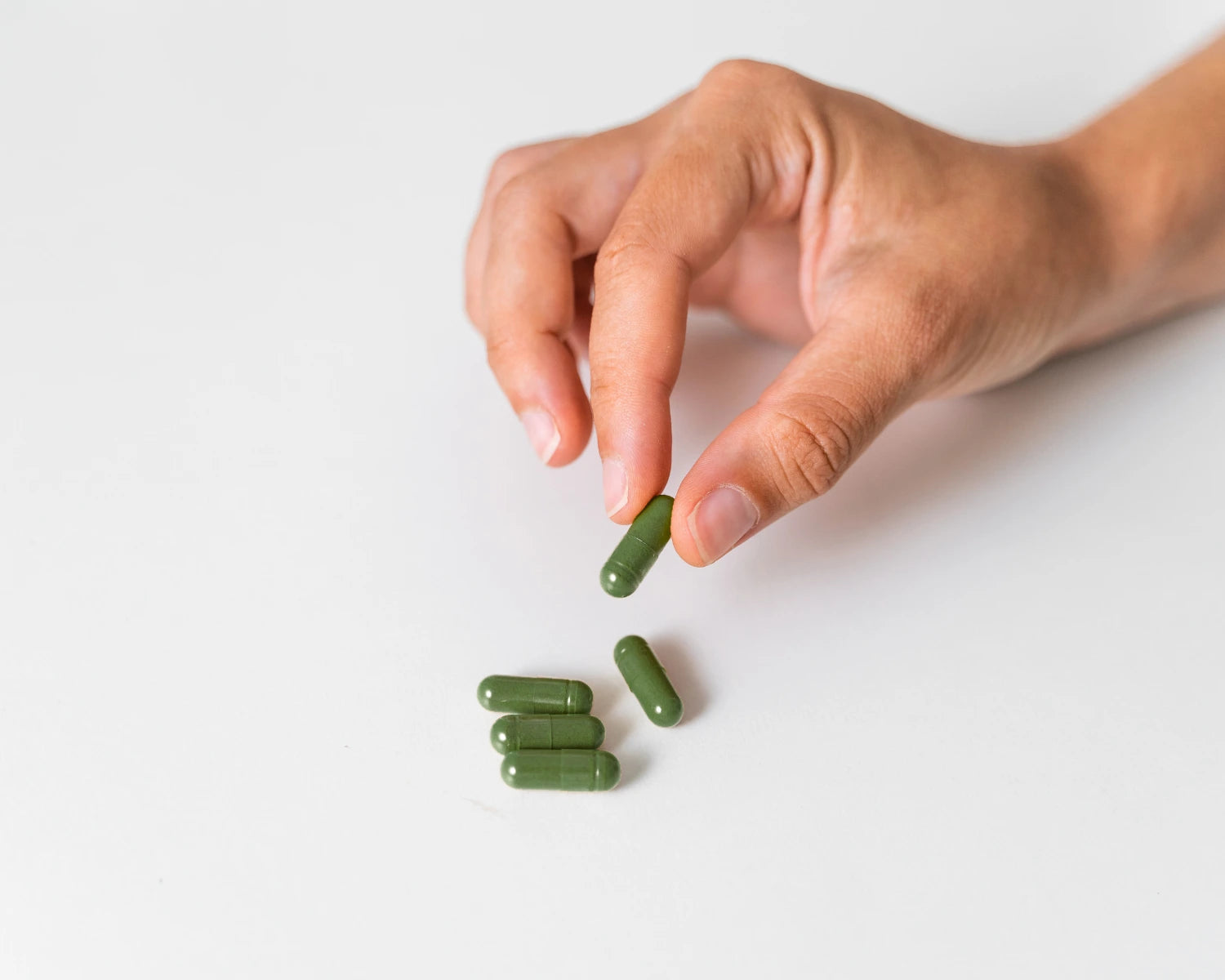 Closeup of hand choosing E3AFA Capsules