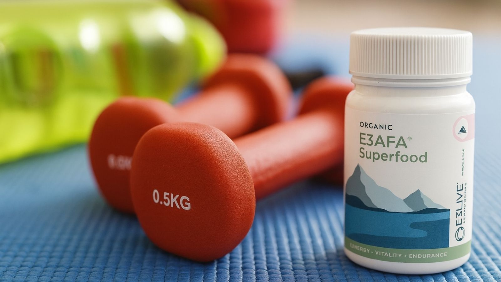 Bottle of E3AFA Superfood with red dumbbells on a blue surface