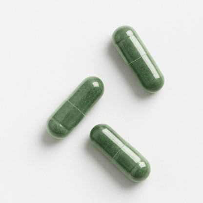 Three green E3AFA capsules on a white background