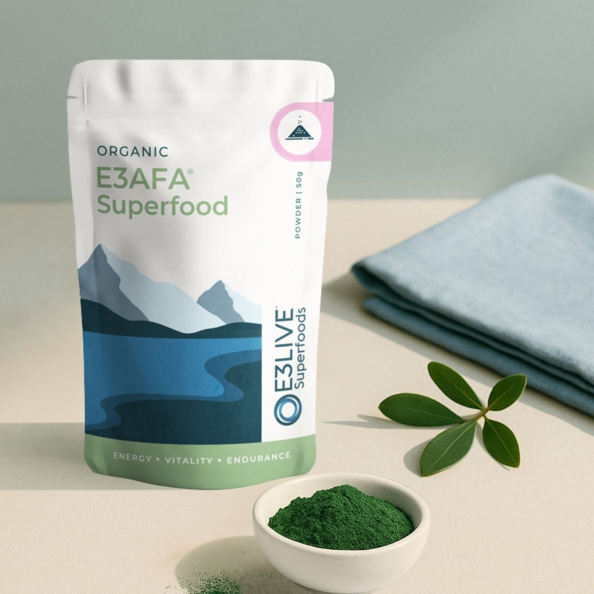 E3AFA Superfood package with a bowl of green powder on a light surface