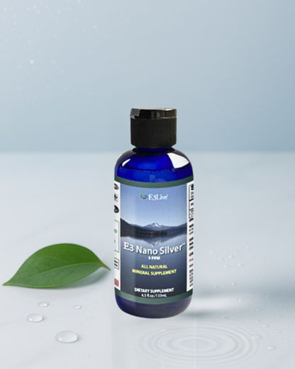 Bottle of E3 Nano Silver supplement with a green leaf on a light gray background