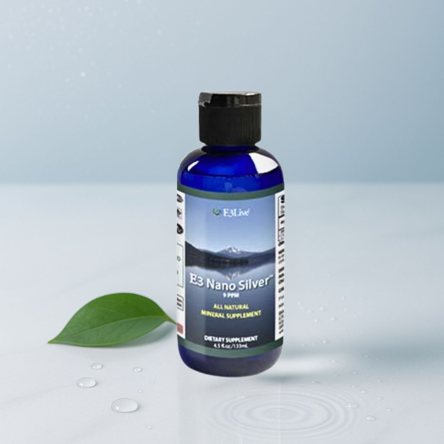 Bottle of E3 Nano Silver supplement with a green leaf on a light gray background