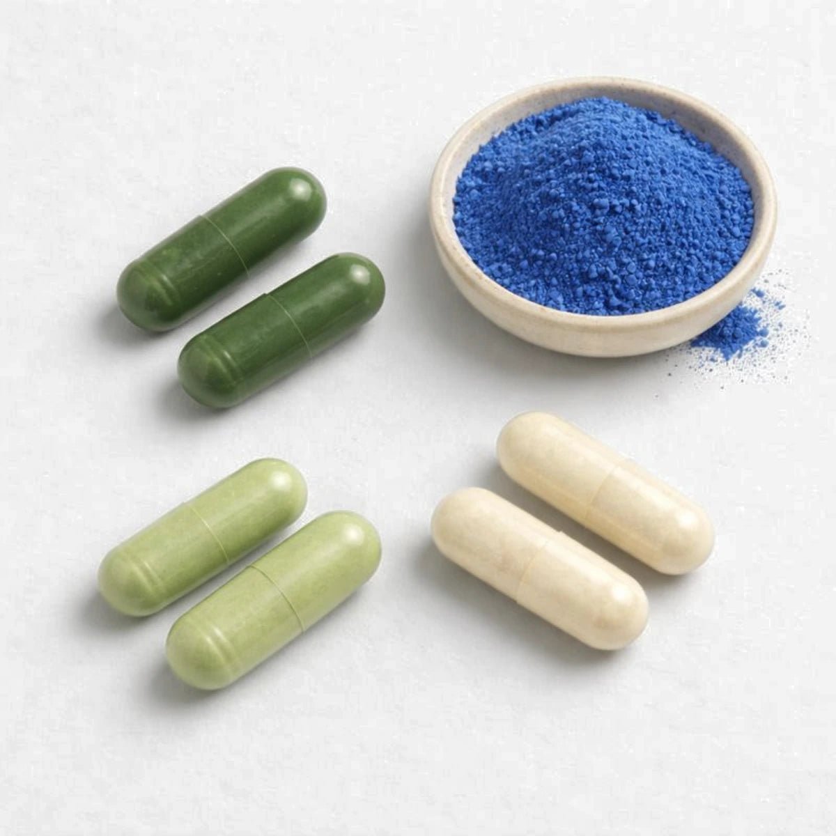 E3AFA, RenewME, E3PArobiotics, E3Enzymes Supreme loose capsules + BlueMAJIK powder in a small bowl.