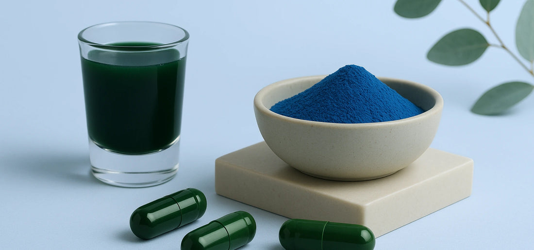 Green liquid in a glass, BlueMAJIK powder in a bowl, and green E3AFA capsules on a light blue background
