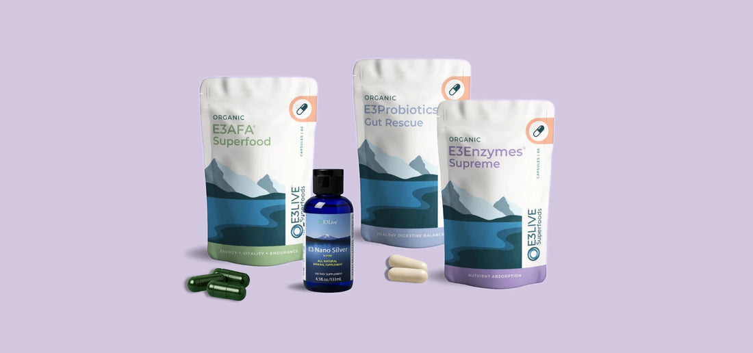 Collection of E3Live products on a light purple background - E3AFA Capsules, E3Probiotics capsules, E3Enzymes Supreme capsules and a bottle of E3 Nano Silver 