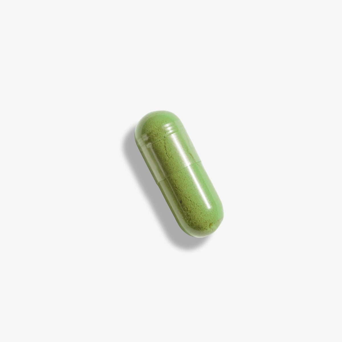Green RenewME capsule on a white background