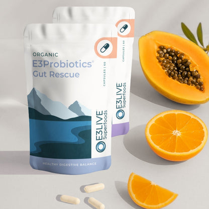 Ultimate Gut Health pack with papaya and orange on a light gray background